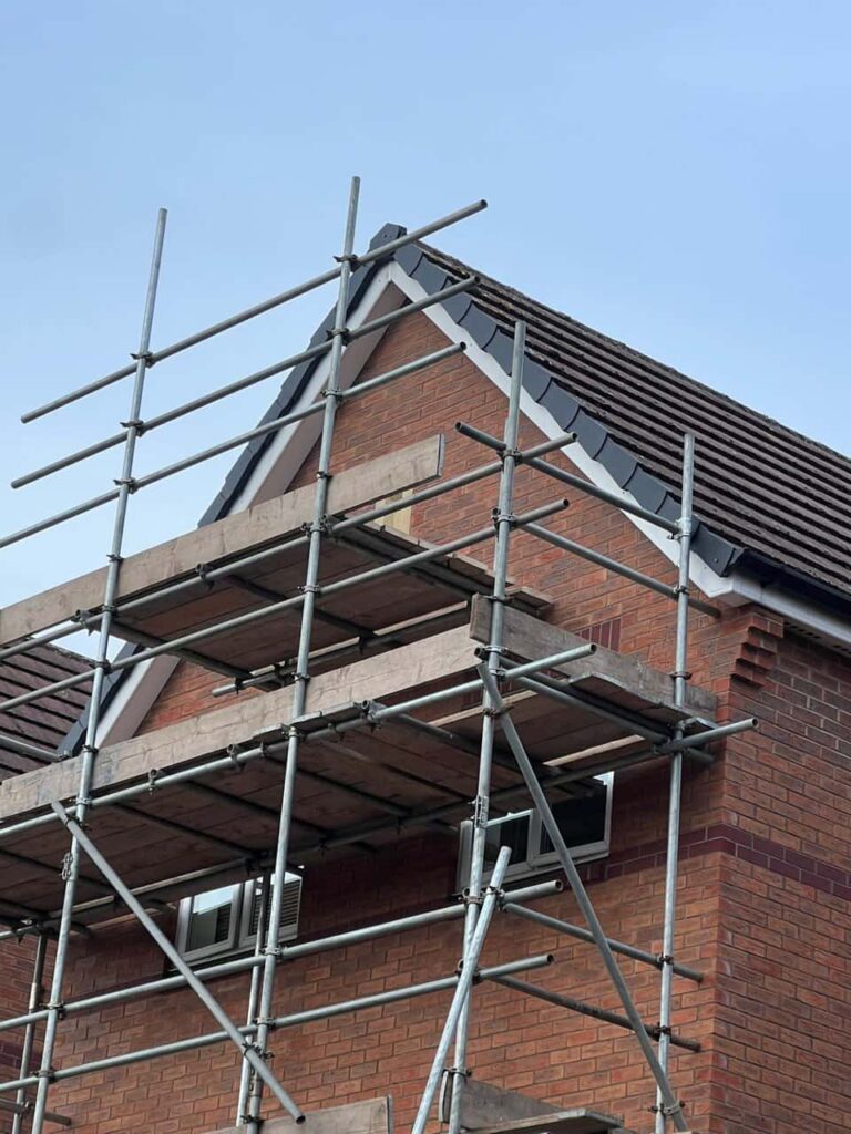 This is a photo of a roof which has just been repaired. There is a scaffold located at the gable end for access onto the roof. Works carried out by MCM Roofing Repairs Lymington