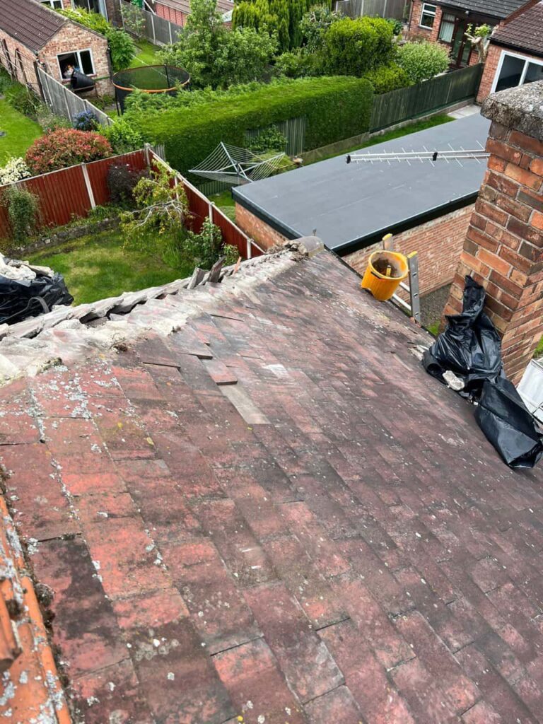 This is a photo of a roof where the hip tiles have been removed, and are just about to be replaced. Works carried out by MCM Roofing Repairs Lymington